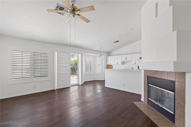 6209 Lenaking Ave, Las Vegas, NV 89122 - unfurnished living room with lofted ceiling, a tile fireplace, dark wood-style floors, and a ceiling fan