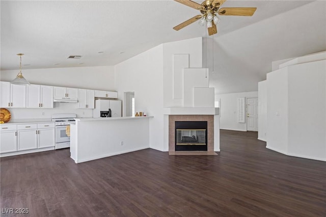 6209 Lenaking Ave, Las Vegas, NV 89122 - unfurnished living room featuring high vaulted ceiling, ceiling fan, dark wood finished floors, and a tile fireplace