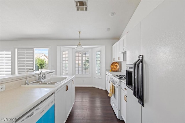 6209 Lenaking Ave, Las Vegas, NV 89122 - kitchen with white appliances, dark wood-style floors, healthy amount of natural light, and white cabinets