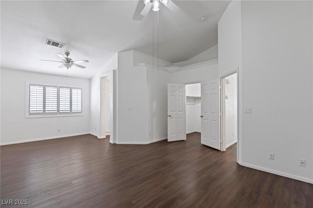6209 Lenaking Ave, Las Vegas, NV 89122 - unfurnished living room featuring a ceiling fan, dark wood-style floors, and vaulted ceiling