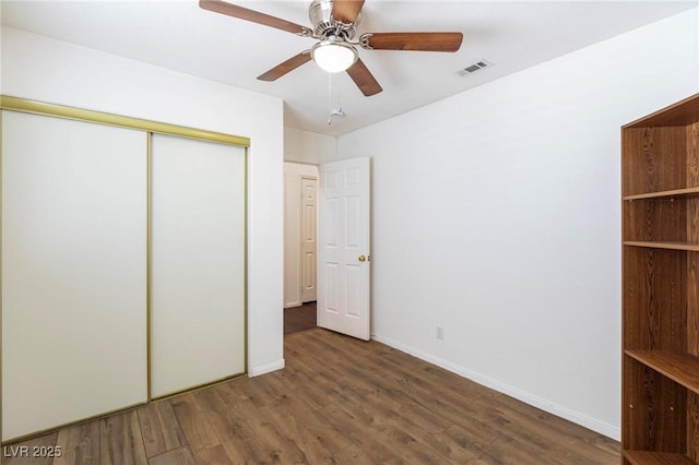 6209 Lenaking Ave, Las Vegas, NV 89122 - unfurnished bedroom with a closet, wood finished floors, and a ceiling fan