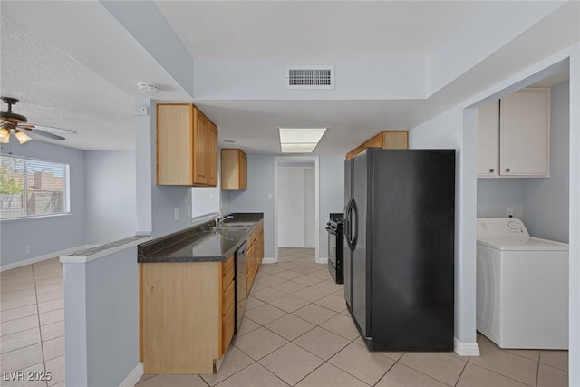 4784 El Escorial Dr, Las Vegas, NV 89121 - kitchen with washer / clothes dryer, black fridge, light tile patterned flooring, and a ceiling fan