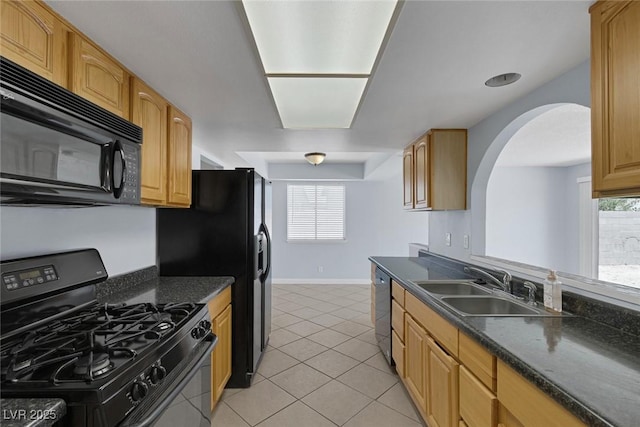 4784 El Escorial Dr, Las Vegas, NV 89121 - kitchen featuring black appliances, arched walkways, light tile patterned floors, and healthy amount of natural light