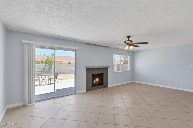 4784 El Escorial Dr, Las Vegas, NV 89121 - unfurnished living room with a textured ceiling, a lit fireplace, and a ceiling fan