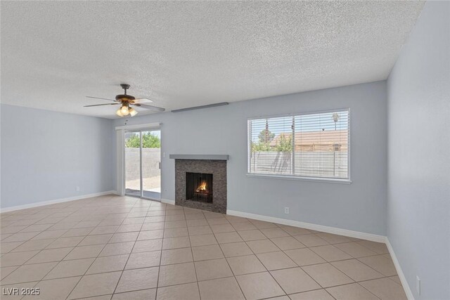 4784 El Escorial Dr, Las Vegas, NV 89121 - unfurnished living room with a textured ceiling, a warm lit fireplace, and a ceiling fan
