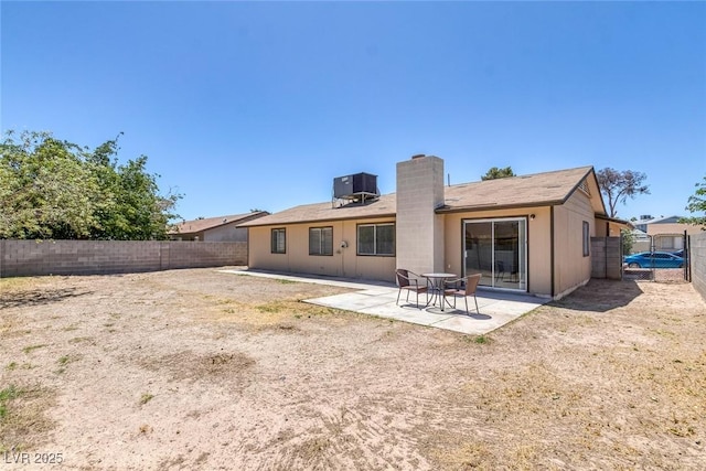 4784 El Escorial Dr, Las Vegas, NV 89121 - back of property with a chimney, a fenced backyard, and a patio