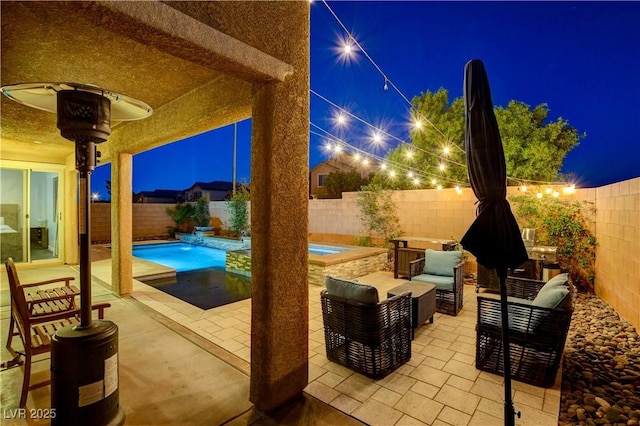 7311 Spring Flower Ave, Las Vegas, NV 89117 - patio at twilight featuring a patio area, a fenced backyard, and an outdoor hangout area