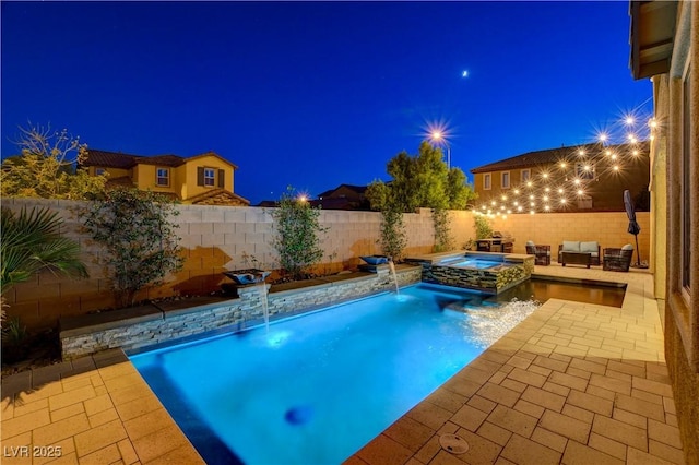 7311 Spring Flower Ave, Las Vegas, NV 89117 - pool at night with a patio, a fenced backyard, and a pool with connected hot tub