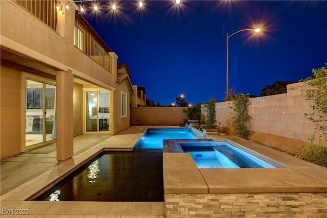 7311 Spring Flower Ave, Las Vegas, NV 89117 - pool at twilight featuring an in-ground hot tub, a fenced backyard, and a patio