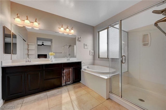 7311 Spring Flower Ave, Las Vegas, NV 89117 - bathroom with a stall shower, a bath, a ceiling fan, double vanity, and tile patterned floors