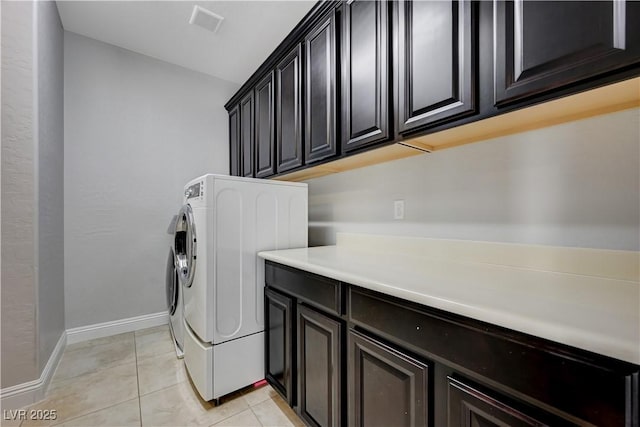 7311 Spring Flower Ave, Las Vegas, NV 89117 - laundry room featuring cabinet space, light tile patterned flooring, and washer and dryer
