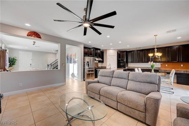 7311 Spring Flower Ave, Las Vegas, NV 89117 - living room featuring light tile patterned flooring, ceiling fan, a chandelier, recessed lighting, and stairs
