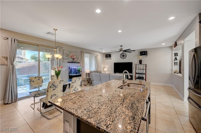 7311 Spring Flower Ave, Las Vegas, NV 89117 - kitchen with freestanding refrigerator, plenty of natural light, ceiling fan, an island with sink, and recessed lighting