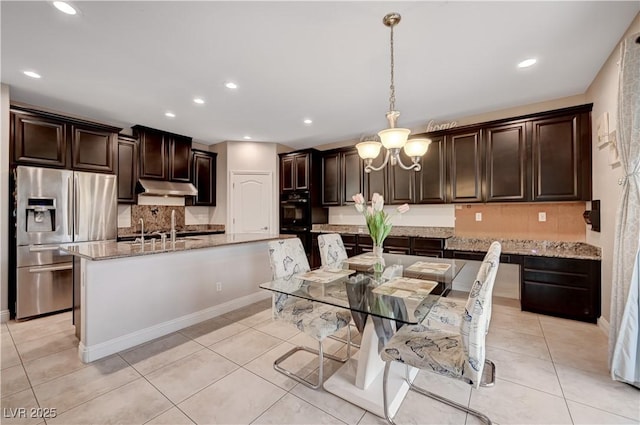 7311 Spring Flower Ave, Las Vegas, NV 89117 - kitchen featuring stainless steel fridge, under cabinet range hood, decorative backsplash, dark brown cabinets, and recessed lighting