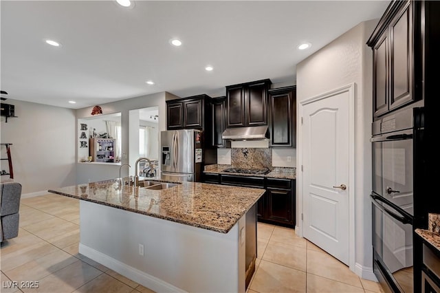 7311 Spring Flower Ave, Las Vegas, NV 89117 - kitchen with stainless steel fridge, under cabinet range hood, light stone countertops, light tile patterned floors, and recessed lighting