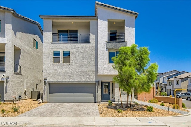 5804 Gossamer Stone Ct, Las Vegas, NV 89141 - contemporary home featuring a balcony, stucco siding, and a garage