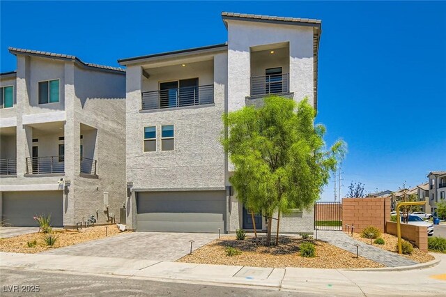 5804 Gossamer Stone Ct, Las Vegas, NV 89141 - view of front of house featuring stucco siding, an attached garage, driveway, and a balcony
