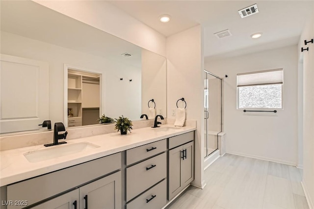 5804 Gossamer Stone Ct, Las Vegas, NV 89141 - bathroom with a shower stall, double vanity, and recessed lighting