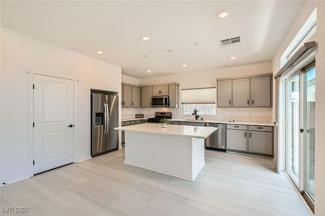 5804 Gossamer Stone Ct, Las Vegas, NV 89141 - kitchen featuring stainless steel appliances, gray cabinetry, light countertops, a center island, and recessed lighting