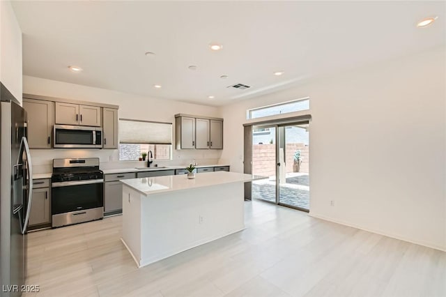 5804 Gossamer Stone Ct, Las Vegas, NV 89141 - kitchen with stainless steel appliances, gray cabinetry, a center island, and recessed lighting