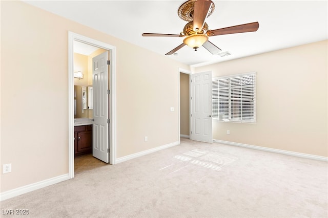 2755 Asgard Ave, Las Vegas, NV 89121 - unfurnished bedroom featuring light carpet, connected bathroom, and ceiling fan