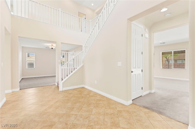 2755 Asgard Ave, Las Vegas, NV 89121 - stairway featuring tile patterned flooring, carpet floors, and a towering ceiling