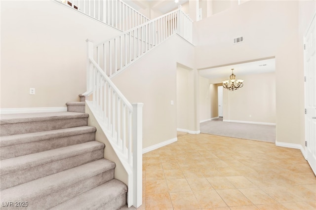 2755 Asgard Ave, Las Vegas, NV 89121 - staircase with a chandelier, a high ceiling, and tile patterned flooring