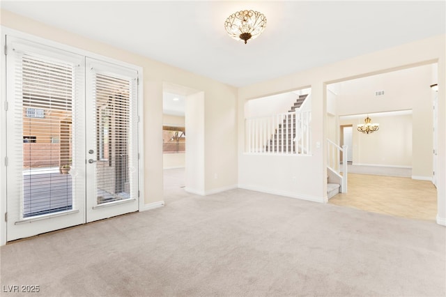 2755 Asgard Ave, Las Vegas, NV 89121 - carpeted empty room featuring stairway, a chandelier, and french doors