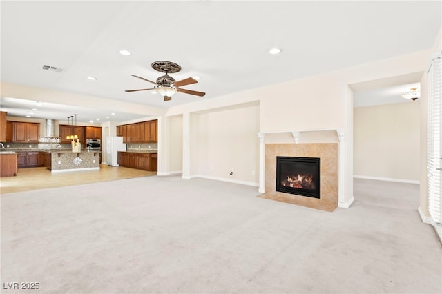 2755 Asgard Ave, Las Vegas, NV 89121 - unfurnished living room featuring a fireplace, light carpet, recessed lighting, and a ceiling fan