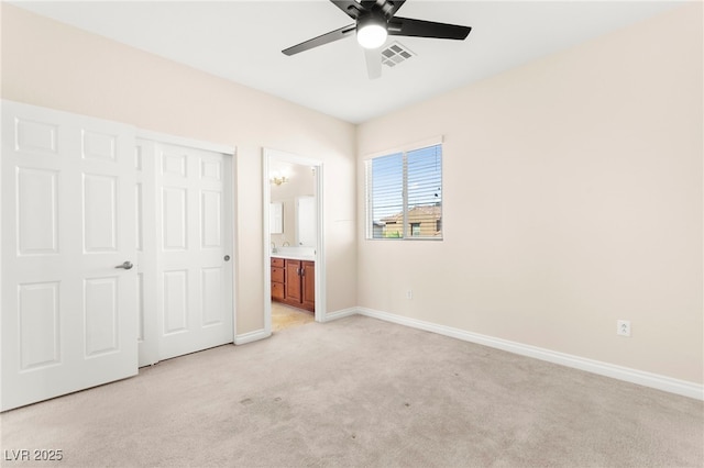 2755 Asgard Ave, Las Vegas, NV 89121 - unfurnished bedroom with light carpet, ensuite bath, and ceiling fan