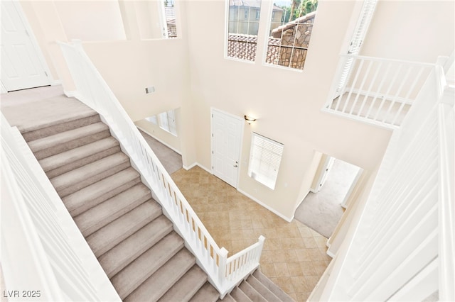 2755 Asgard Ave, Las Vegas, NV 89121 - stairway with a high ceiling, carpet floors, and tile patterned floors