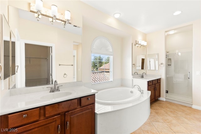 2755 Asgard Ave, Las Vegas, NV 89121 - full bathroom with a stall shower, two vanities, a garden tub, and tile patterned flooring