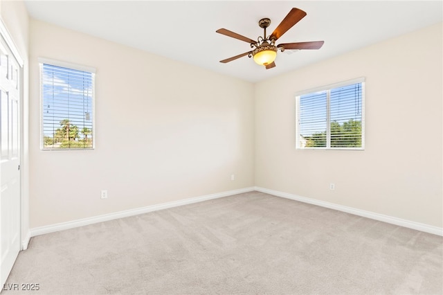 2755 Asgard Ave, Las Vegas, NV 89121 - unfurnished room with light colored carpet, plenty of natural light, and a ceiling fan