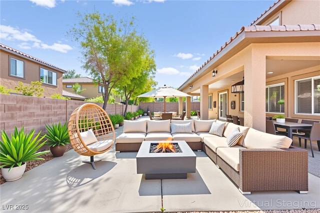 2755 Asgard Ave, Las Vegas, NV 89121 - fenced backyard featuring an outdoor living space with a fire pit, a patio area, and outdoor dining area