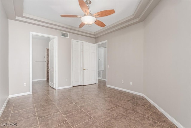 224 Morgyn Ln Unit 6, Boulder City, NV 89005 - unfurnished bedroom with a raised ceiling, tile patterned flooring, a closet, and a ceiling fan