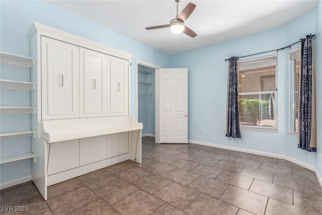 224 Morgyn Ln Unit 6, Boulder City, NV 89005 - unfurnished bedroom featuring tile patterned floors, a ceiling fan, and a closet