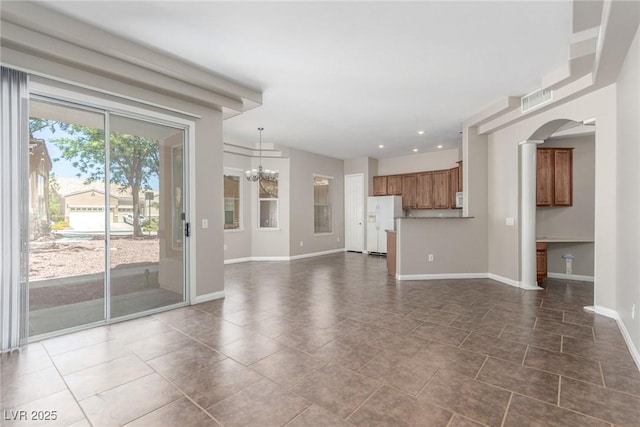 224 Morgyn Ln Unit 6, Boulder City, NV 89005 - unfurnished living room with a chandelier, arched walkways, recessed lighting, and dark tile patterned flooring