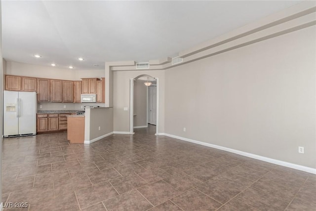 224 Morgyn Ln Unit 6, Boulder City, NV 89005 - kitchen featuring white appliances, recessed lighting, arched walkways, open floor plan, and light countertops