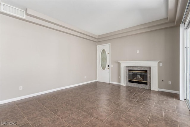 224 Morgyn Ln Unit 6, Boulder City, NV 89005 - unfurnished living room featuring a tray ceiling, a premium fireplace, and dark tile patterned flooring