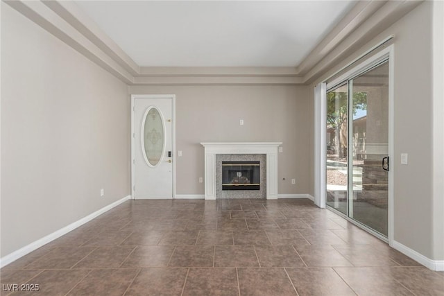 224 Morgyn Ln Unit 6, Boulder City, NV 89005 - unfurnished living room with a raised ceiling, a glass covered fireplace, and dark tile patterned floors