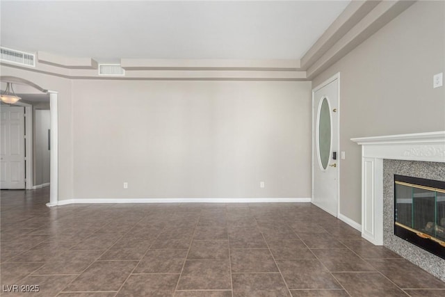 224 Morgyn Ln Unit 6, Boulder City, NV 89005 - unfurnished living room featuring dark tile patterned flooring, a fireplace, and arched walkways