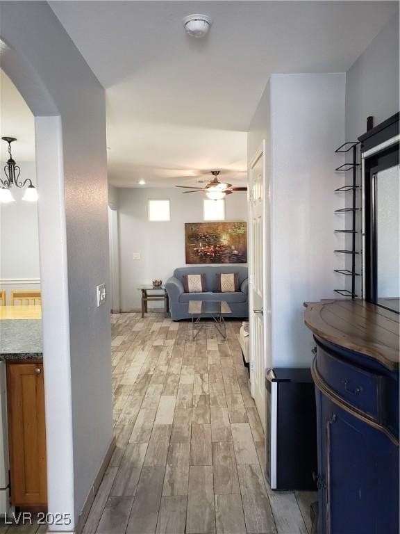 6283 Lapilli Ave, Las Vegas, NV 89139 - corridor with light wood-style flooring and arched walkways