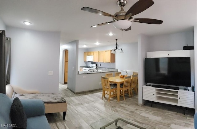 6283 Lapilli Ave, Las Vegas, NV 89139 - living area featuring ceiling fan, light wood-style floors, arched walkways, and recessed lighting