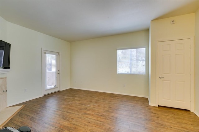 5250 S Rainbow Blvd Unit 2101, Las Vegas, NV 89118 - unfurnished living room featuring wood finished floors and baseboards