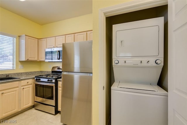 5250 S Rainbow Blvd Unit 2101, Las Vegas, NV 89118 - washroom featuring stacked washer / dryer and light tile patterned flooring