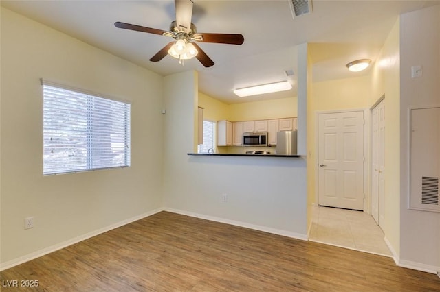 5250 S Rainbow Blvd Unit 2101, Las Vegas, NV 89118 - unfurnished living room with a ceiling fan and light wood-type flooring