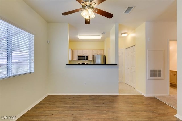 5250 S Rainbow Blvd Unit 2101, Las Vegas, NV 89118 - unfurnished living room featuring light wood-style floors and ceiling fan