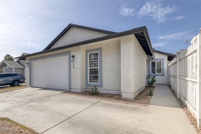 59 N Christy Ln, Las Vegas, NV 89110 - view of home's exterior featuring concrete driveway, a garage, and stucco siding