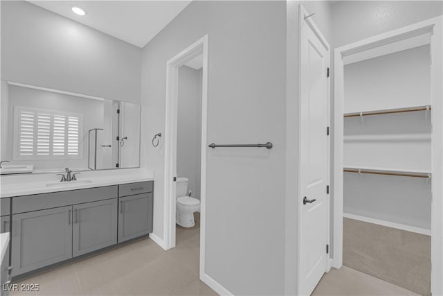 11909 Pippa Ave, Las Vegas, NV 89138 - bathroom with vanity, a spacious closet, and tile patterned flooring