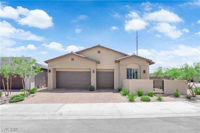 11909 Pippa Ave, Las Vegas, NV 89138 - mediterranean / spanish home with driveway, stucco siding, a garage, and a gate